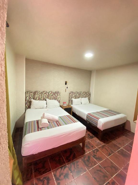 Postel nebo postele na pokoji v ubytování Hotel Flamingos