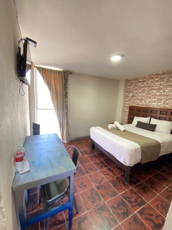 Postel nebo postele na pokoji v ubytování Hotel Flamingos