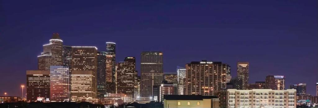 a city skyline at night with tall buildings at Midtown Condo with skyline view in Houston