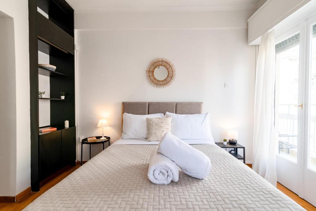 a bedroom with a large bed with towels on it at Exarchia Artistic getaway for groups in Athens