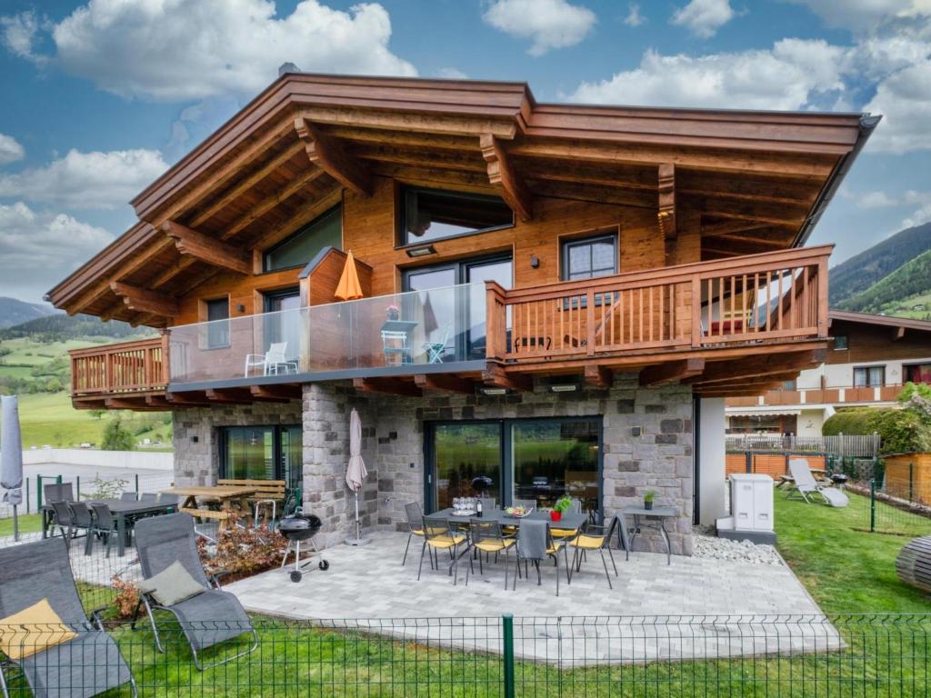a log home with a deck and patio at Bergbiberhaus L in Piesendorf