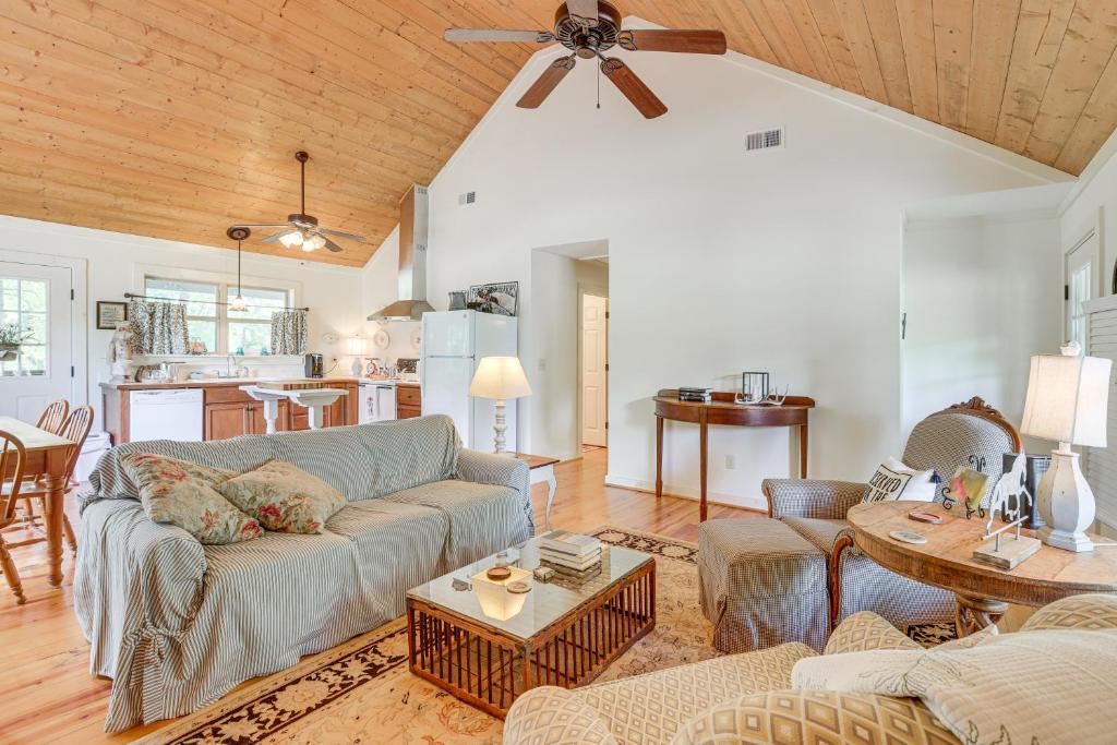 a living room with a couch and a table at Charming Lawley Cottage: Deck, Fire Pit & Yard! in Lawley
