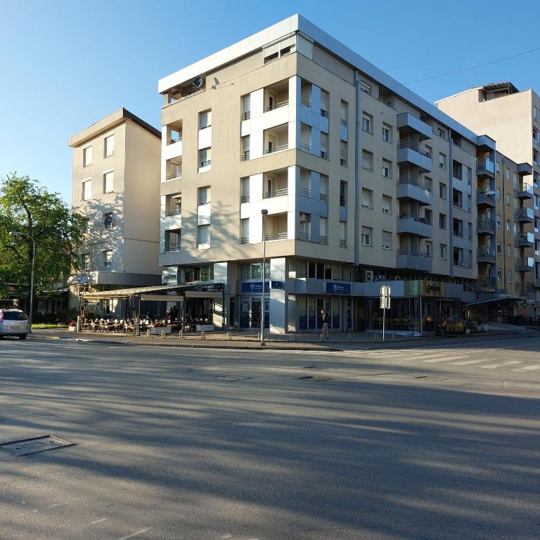 a building on the corner of a street at Index Apartman in Banja Luka