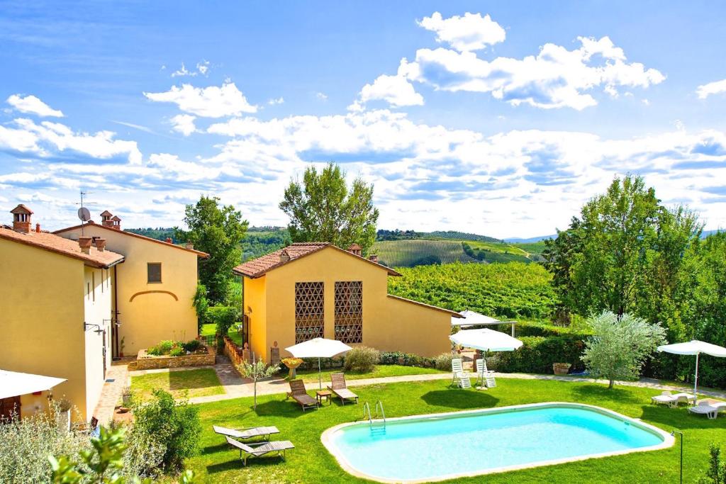 a backyard with a swimming pool and a house at Holiday Home Casa Riccardo in Montespertoli