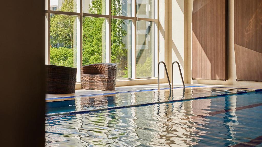 a swimming pool in a building with a large window at LOTTE CITY HOTEL Mapo in Seoul