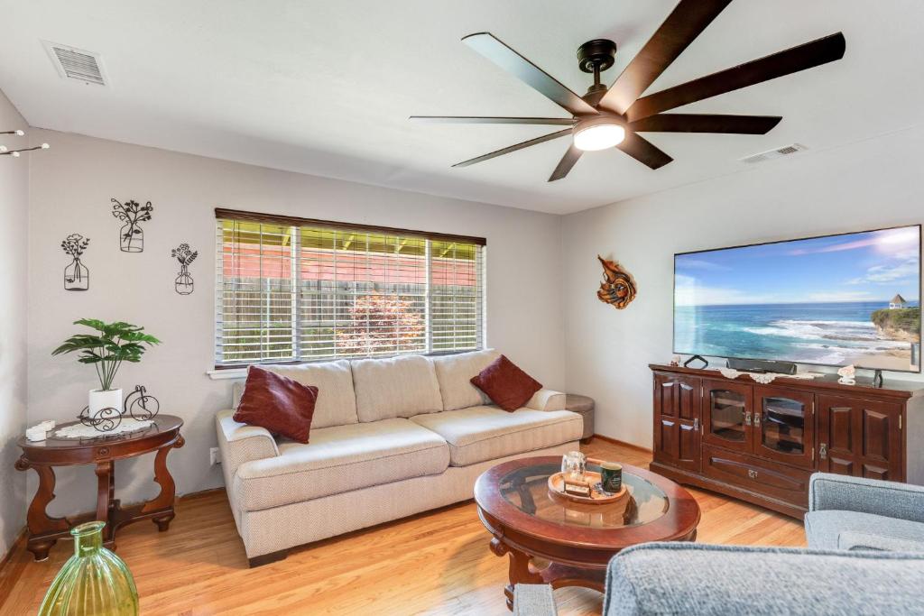 a living room with a couch and a ceiling fan at Charming 2-Bedroom Home With Private Office and Backyard in Rancho Cordova
