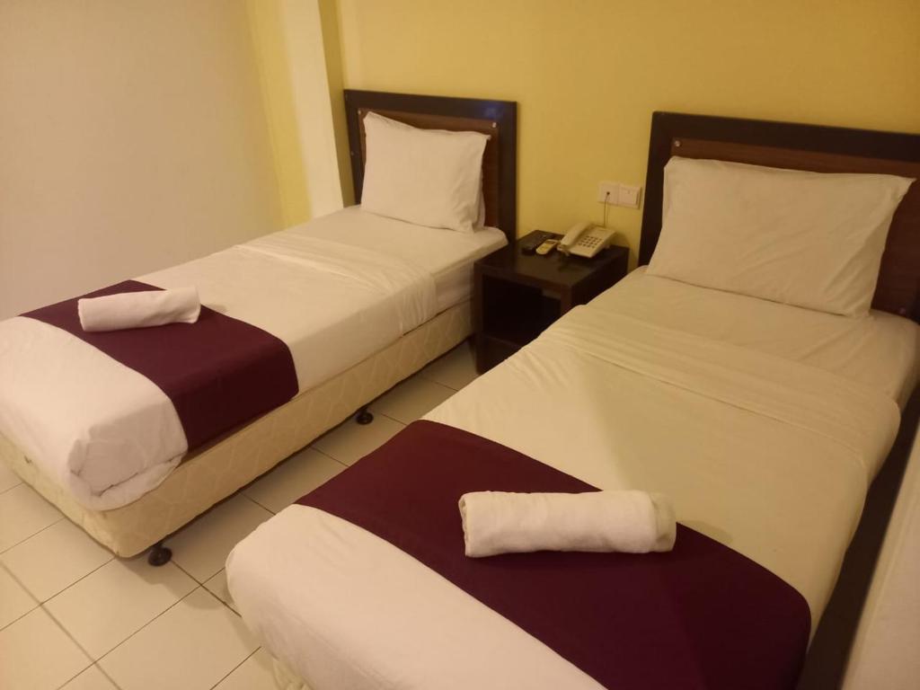 Postel nebo postele na pokoji v ubytování Syajie Koptown Hotel