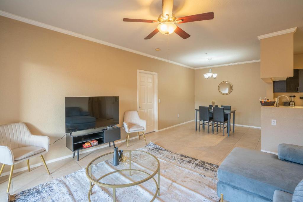 a living room with a flat screen tv and a couch at Modern 2BR Oasis Pool, Gym & Parking Near Airport in Phoenix