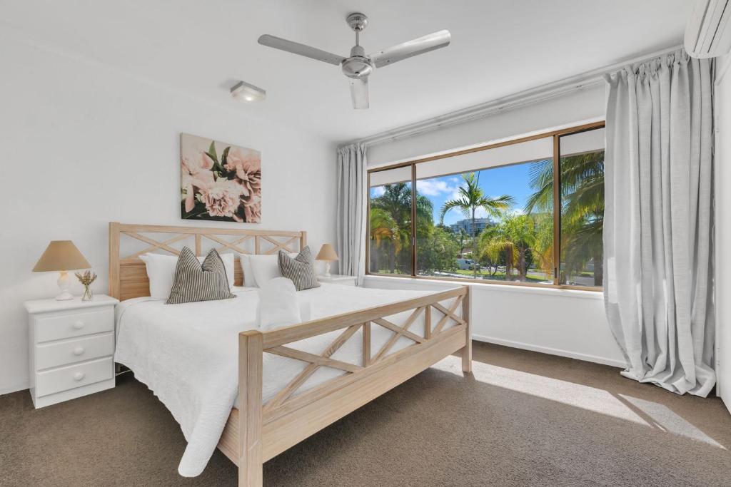 a bedroom with a bed and a large window at 10 Noosa Sound in Noosa Heads