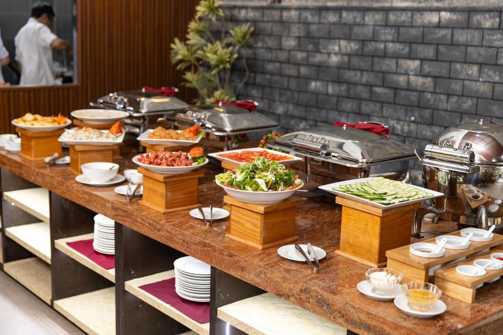 A broad breakfast buffet offers hot dishes, salads, fruit, and drinks.