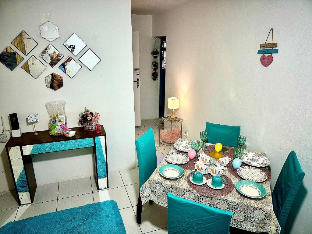 a dining room with a table and blue chairs at Apartamentos a 2 min. da Praia, localização exclusiva in Recife