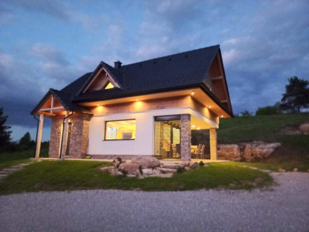 ein kleines Haus mit schwarzem Dach in der Unterkunft Chata Elegant in Bešeňová