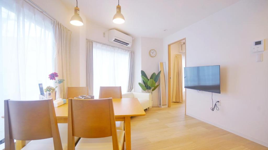 a dining room with a table and a television at TOKYO AKATSUKI HOTEL in Tokyo