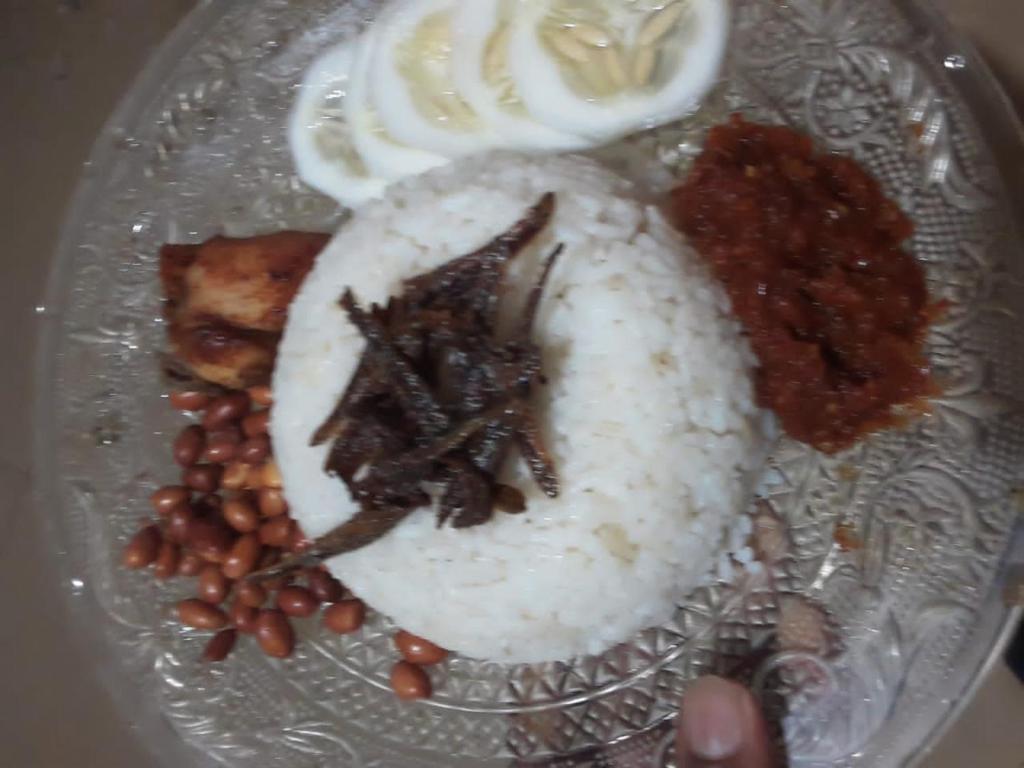 a plate of food with rice and beans and onions at Coco Cabins by Thush in Bentota