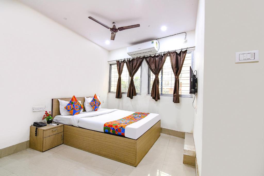 sypialnia z łóżkiem i oknem w obiekcie FabExpress Vhyom Sky Palace w mieście Kolkata