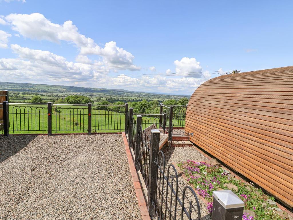 a view from the balcony of a house with a fence at Luna Holiday Pod in Shrewsbury