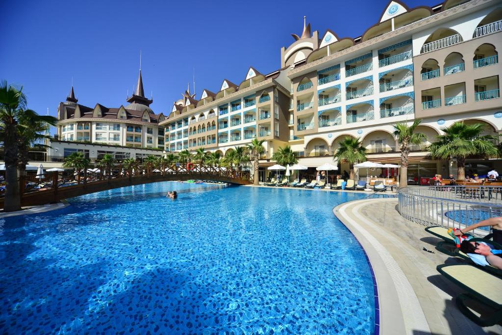 a large swimming pool in front of a hotel at Side Crown Palace Ultra All Inclusive in Side