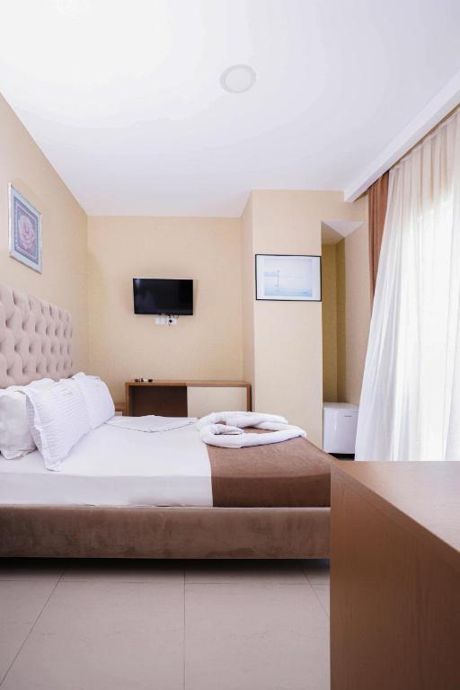 Postel nebo postele na pokoji v ubytování Hotel Frojd - Beach Front Resort