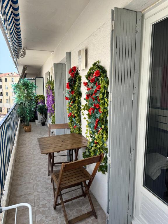- un balcon avec des bancs et des fleurs dans un bâtiment dans l'établissement Studio Charmant, à Cannes