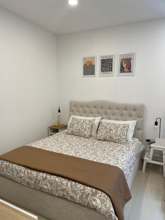 a white bedroom with a large bed in it at GlamByAJ with free parking and Netflix in Pula