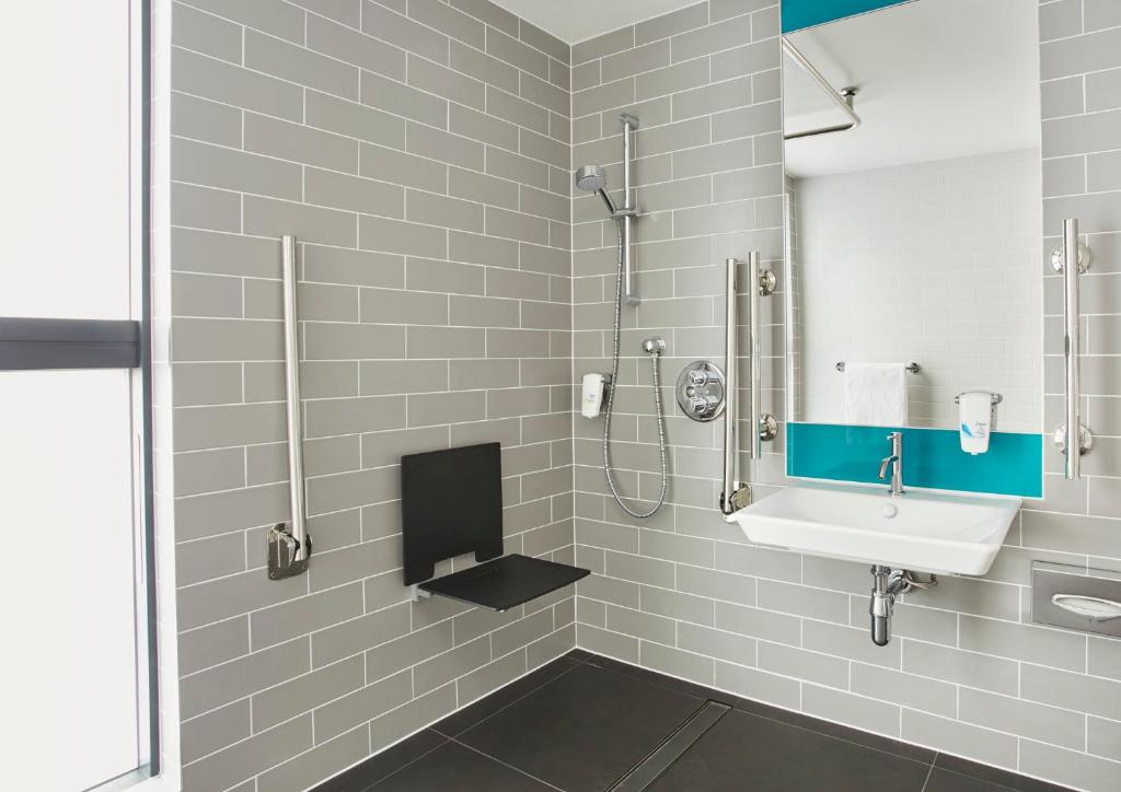 a bathroom with a sink and a shower at Holiday Inn Express Ajaccio by IHG in Ajaccio