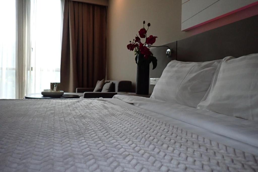 Ліжко або ліжка в номері De Perdana Hotel