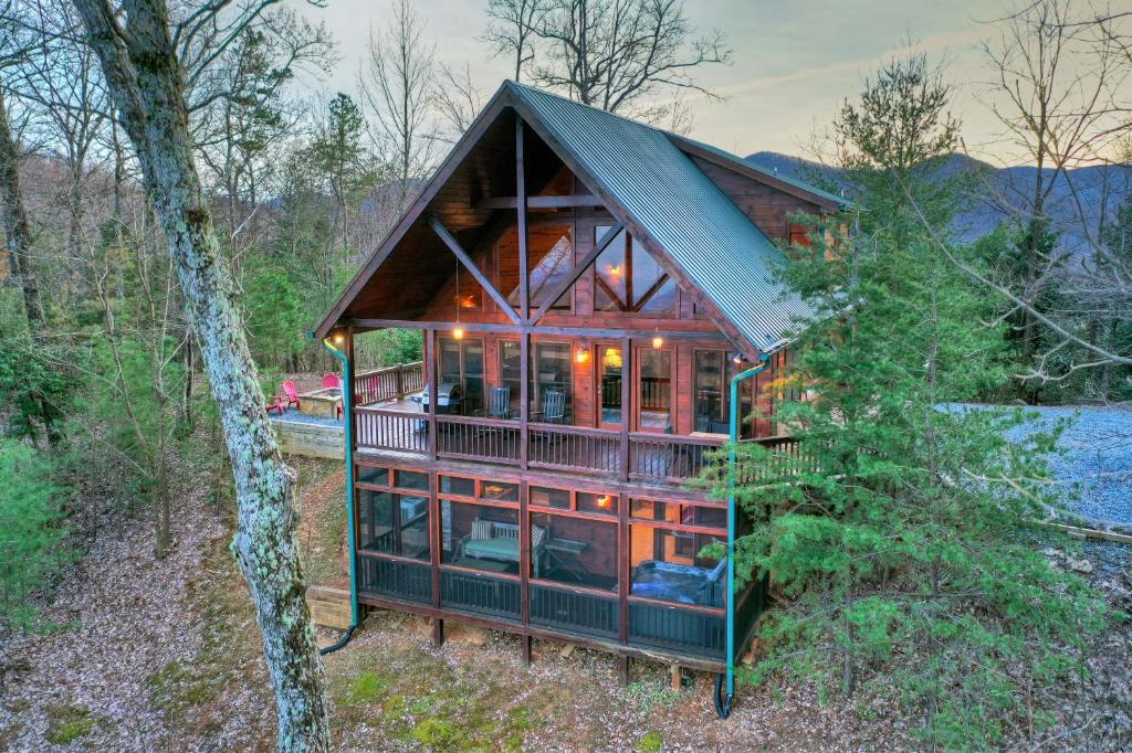 a house in the woods with a large glass facade at Appalachian Sunrise Amazing views Close to Blue Ridge hike from the cabin in Blue Ridge