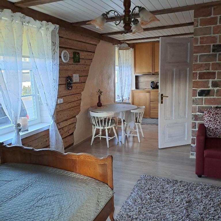 a bedroom with a table and a dining room at Tagalahe Apartment in Haapsalu