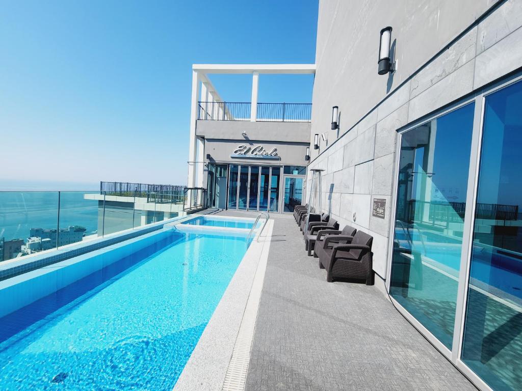 a swimming pool on the roof of a building at Sienna Ambassador Residence in Busan