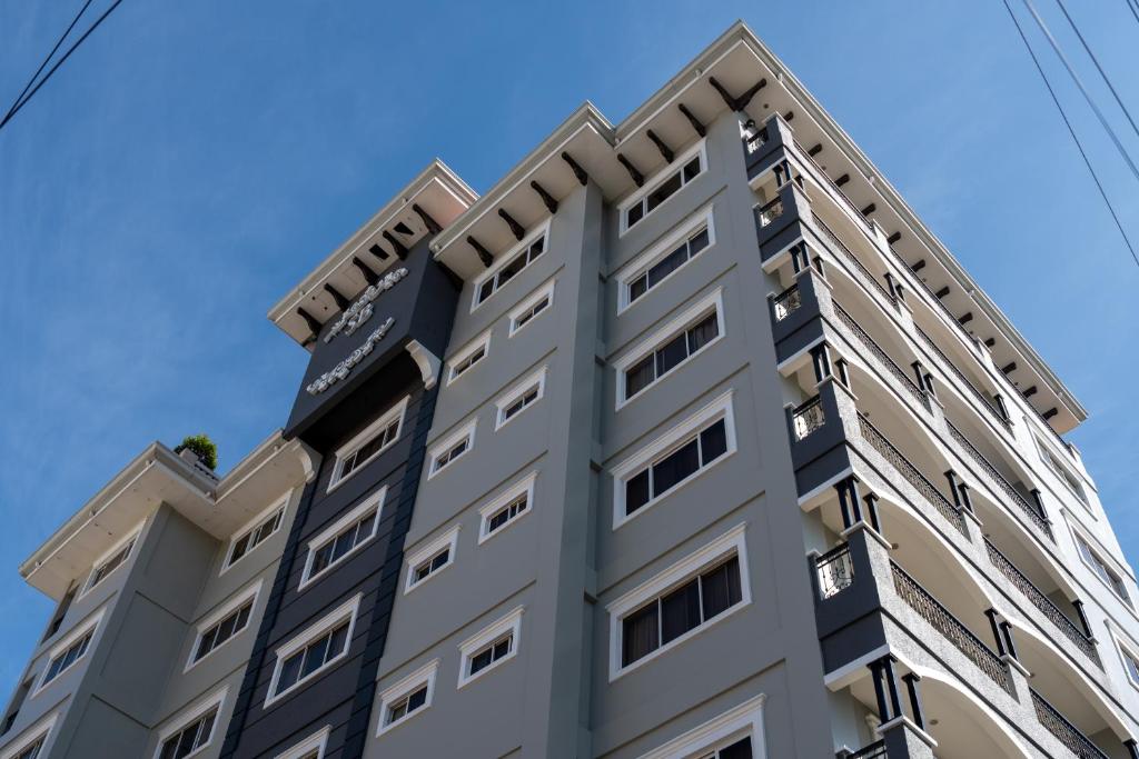 a tall building with a blue sky in the background at Sta Barbara Residence Hotel in Cebu City
