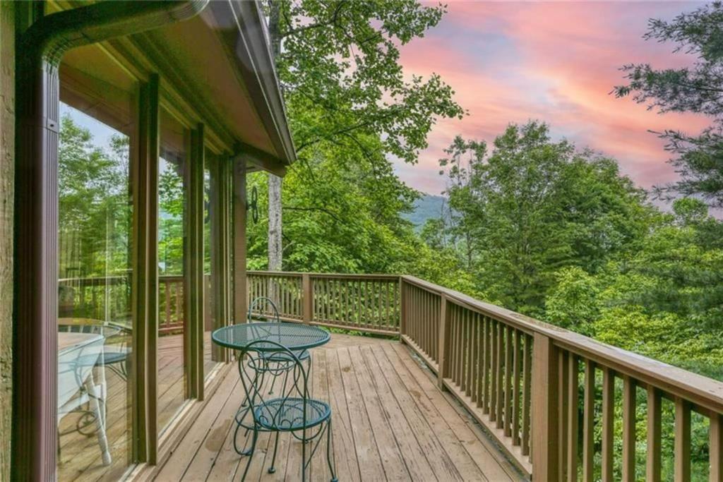 a balcony with a table and chairs on it at Chalet 141 - Peaceful wooded views cozy interiors plus wifi in Marblehill
