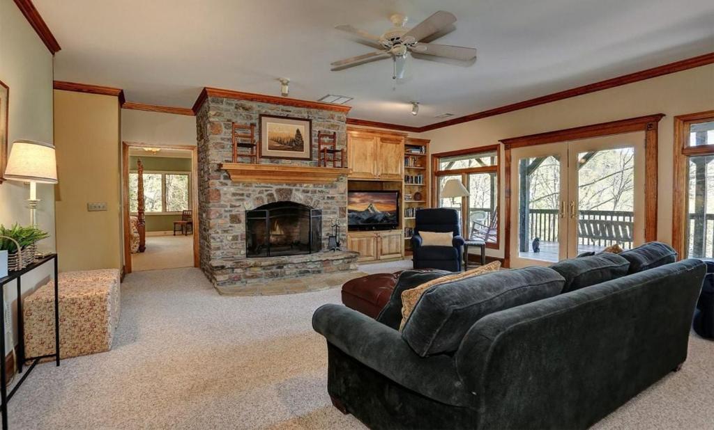 a living room with a couch and a fireplace at Mountain Memories - Viking gas range GE double ovenwarmer Lake views in Marblehill