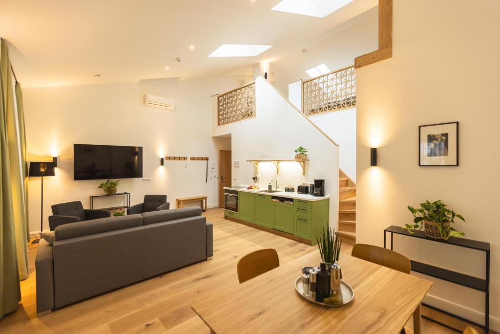 a living room with a couch and a table at the salt vis à vis in Hallein