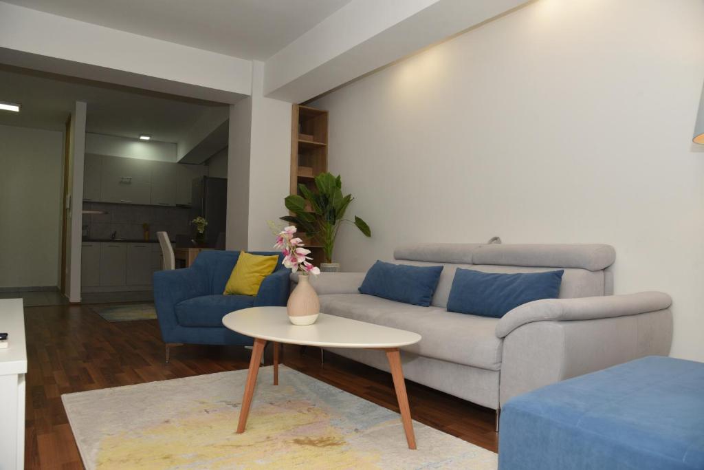 a living room with a couch and a table at Boda Apartments in Skopje