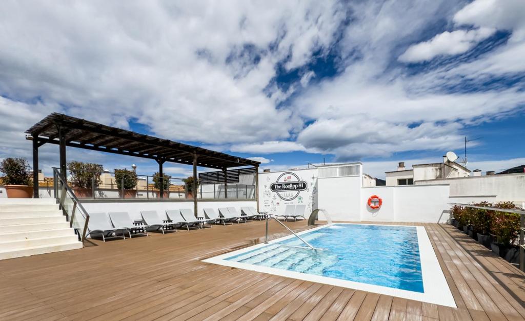 a swimming pool on the roof of a building at Hotel Marina in Roses