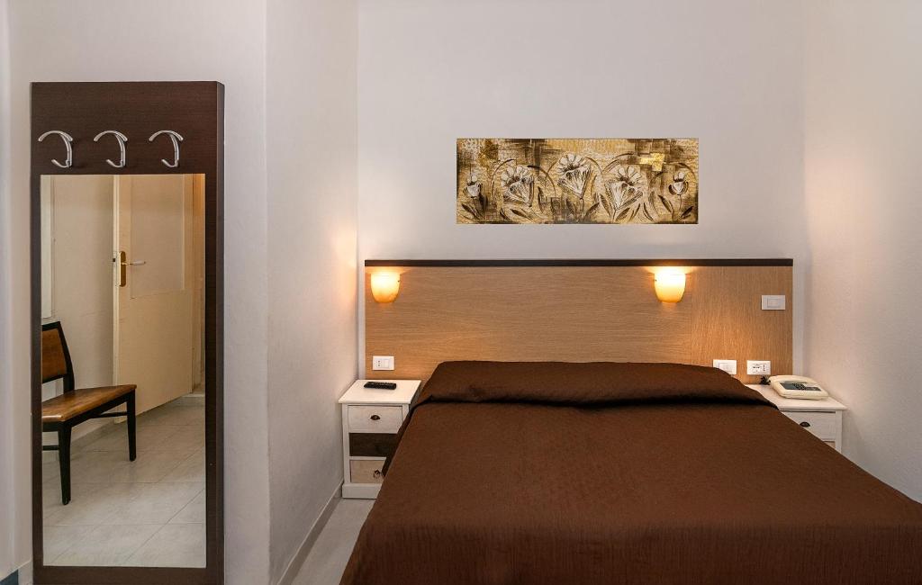 Postel nebo postele na pokoji v ubytování Hotel Rex