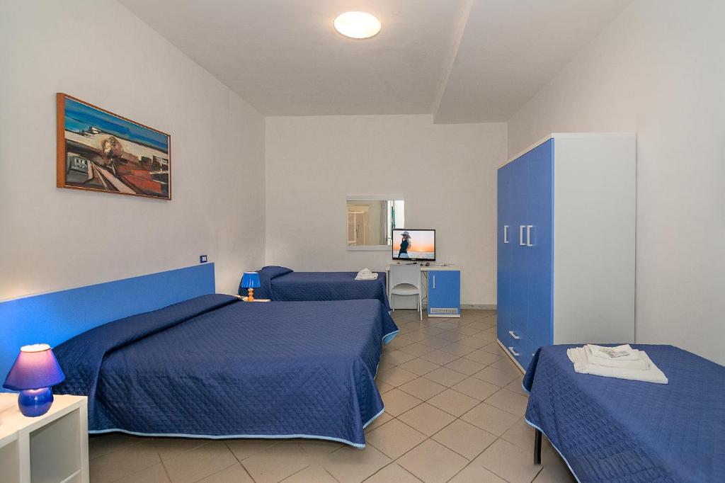 Postel nebo postele na pokoji v ubytování Hotel Rex