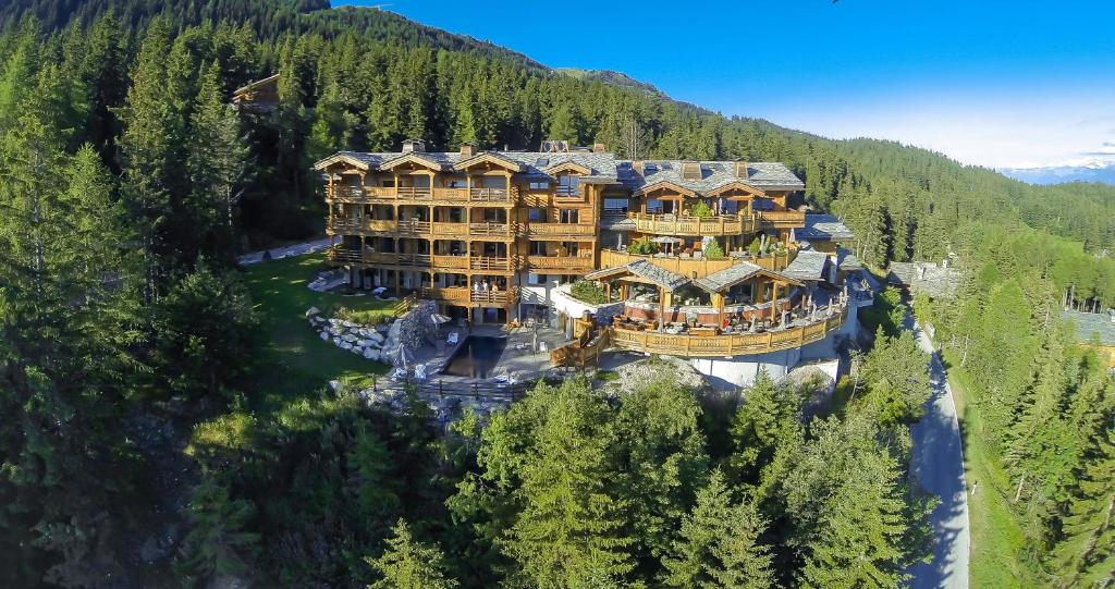 an aerial view of a large building on a river at LeCrans in Crans-Montana