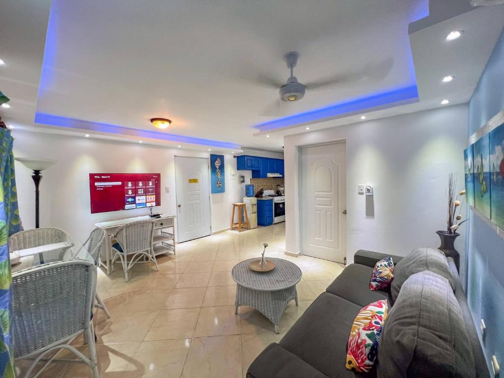a living room with a couch and a table at Garden Condos 43, Modern Condo In Sosa Center in Sosúa