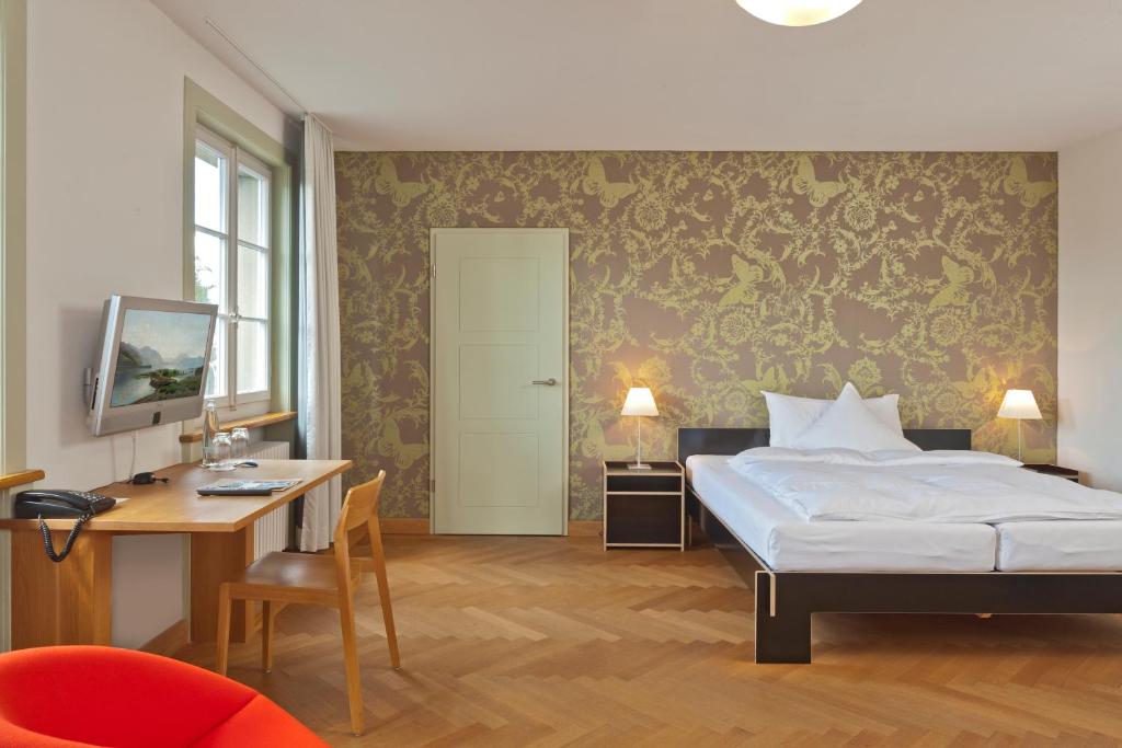 Postel nebo postele na pokoji v ubytování Boutique-Hotel Auberge Langenthal