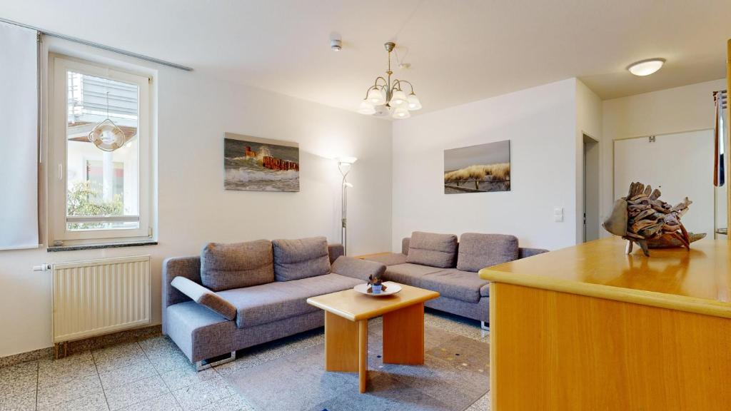 a living room with a couch and a table at a cappella 01 im Binz, strandnahe FeWo mit Schwimmbad im Haus, in Binz