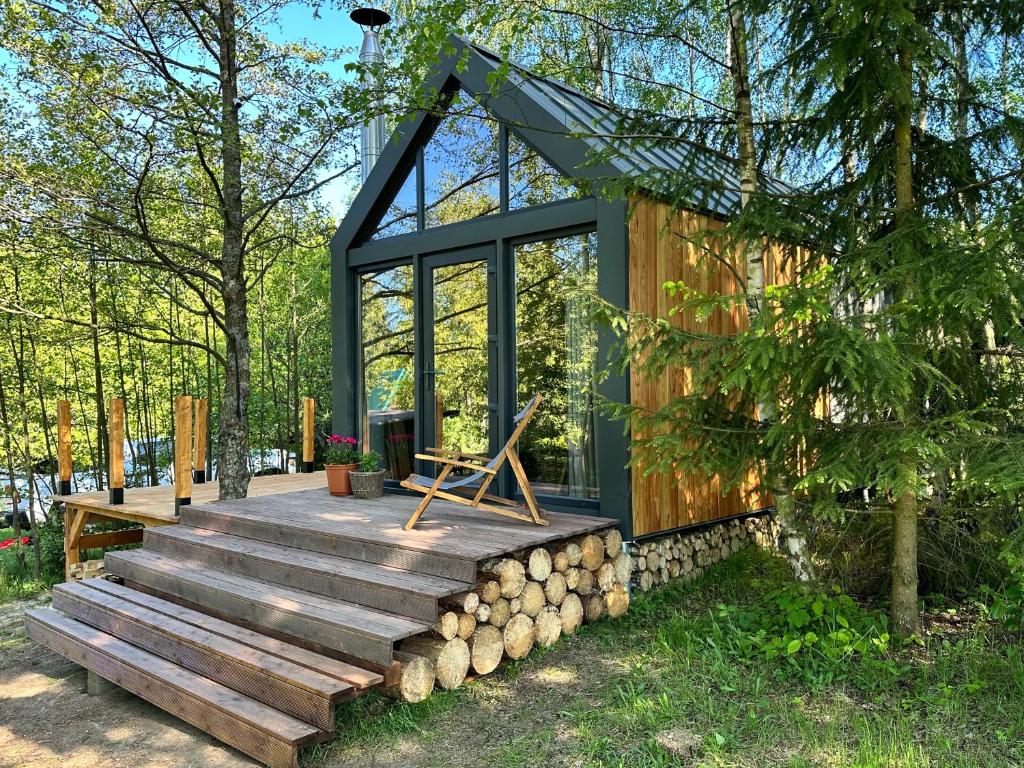una casa pequeña con terraza y ventana en Zbrusu nový luxusní Tiny House kousek od Moravského krasu 