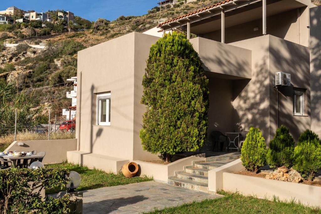 a house with a tree in front of it at Elio A 1BDR Apt with Garden 1 min from the beach by Hospi in Heraklio Town