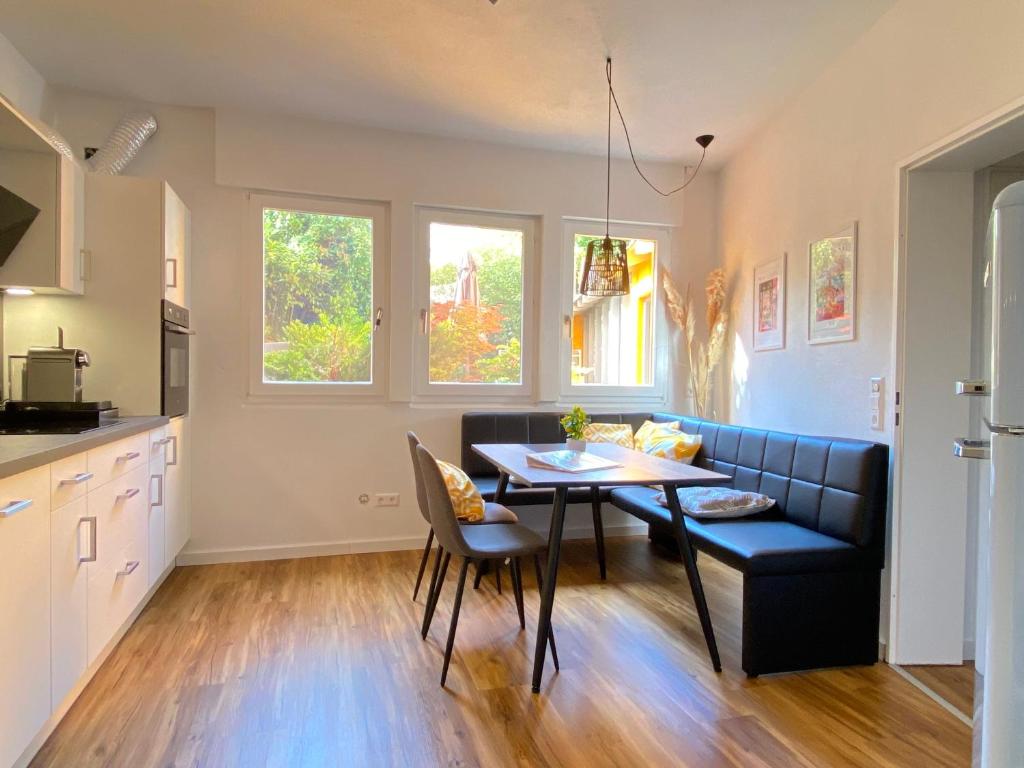 a kitchen and dining room with a table and a couch at Ferienwohnung Seesprung am Bodensee in Gaienhofen