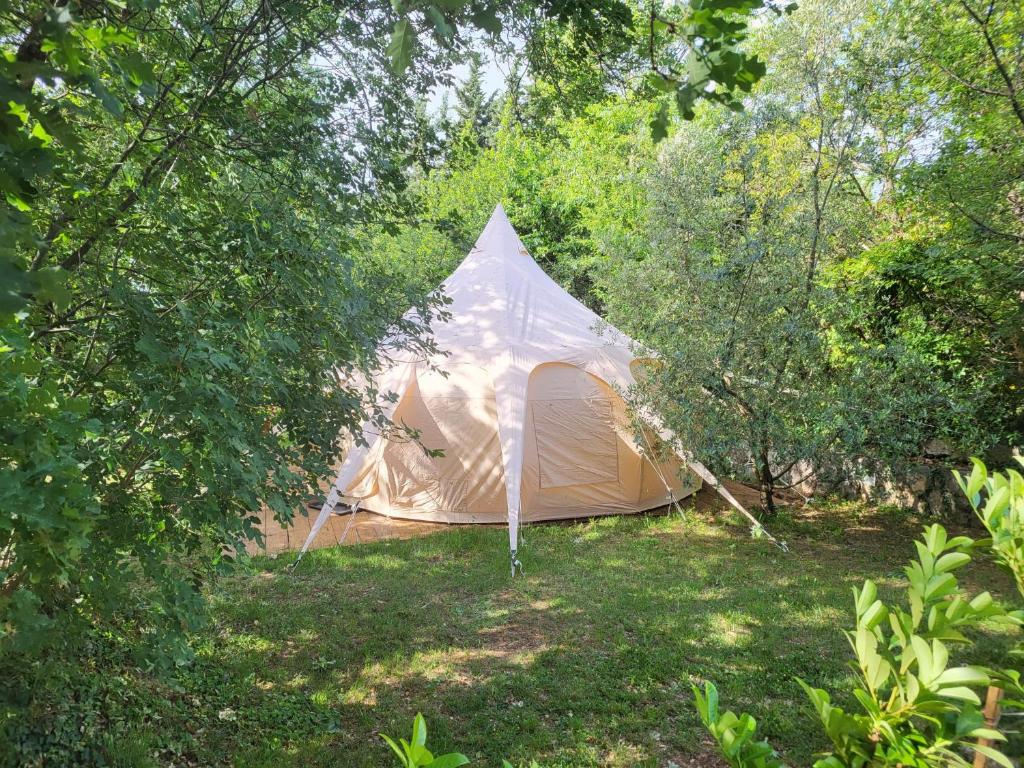 a tent in the middle of a field with trees at Rock Oak Imotski 1 in Imotski