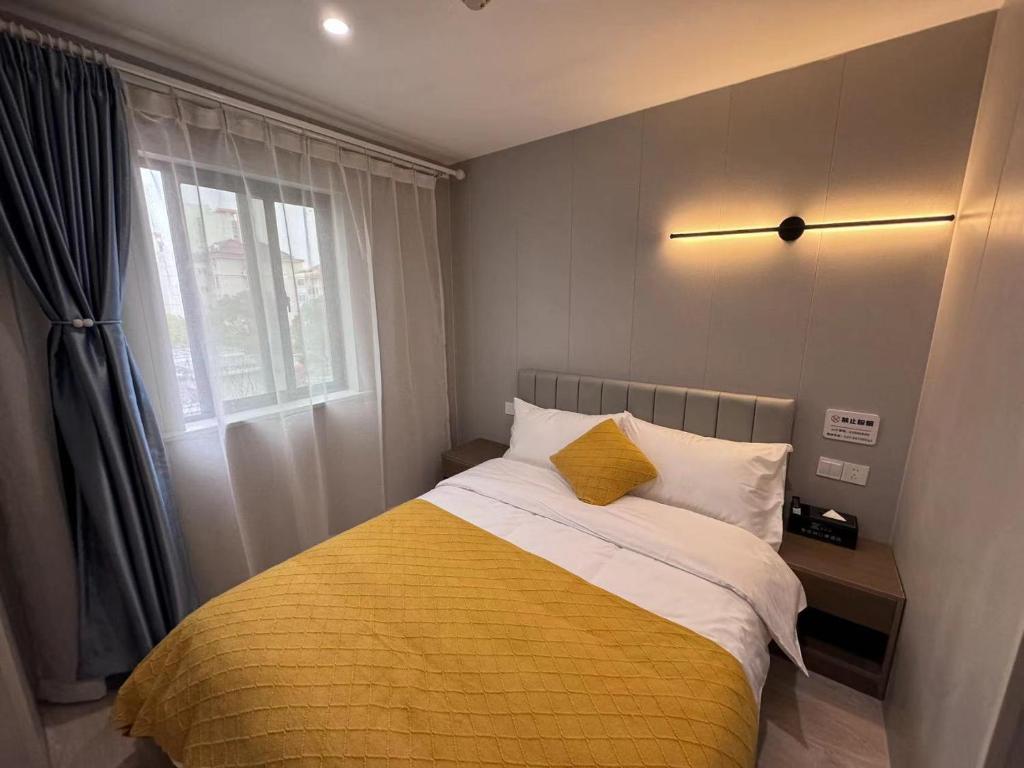 Postel nebo postele na pokoji v ubytování KeTangJian Aparthotel