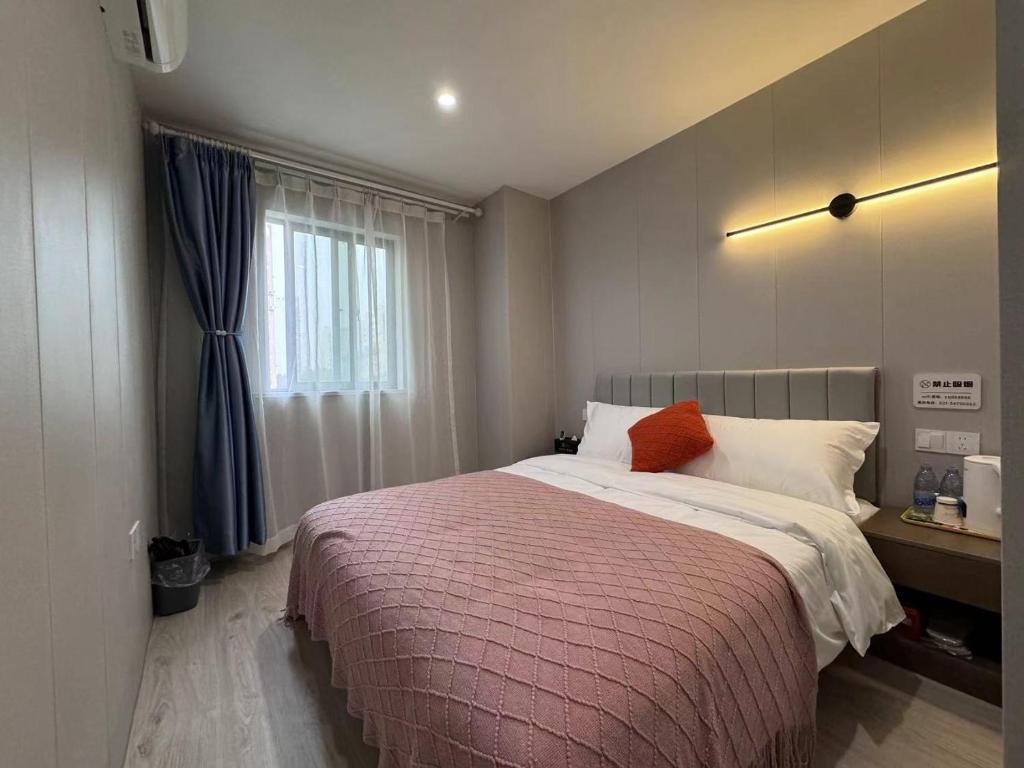 Postel nebo postele na pokoji v ubytování KeTangJian Aparthotel