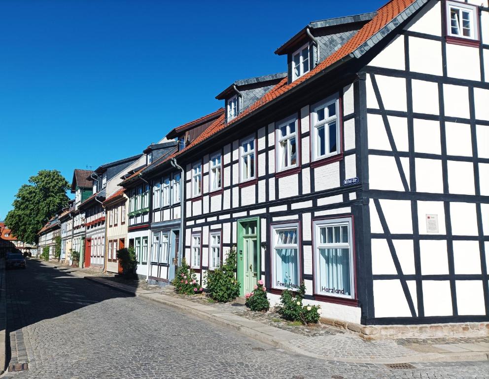 a row of black and white buildings on a street at Haus Harzland in Wernigerode