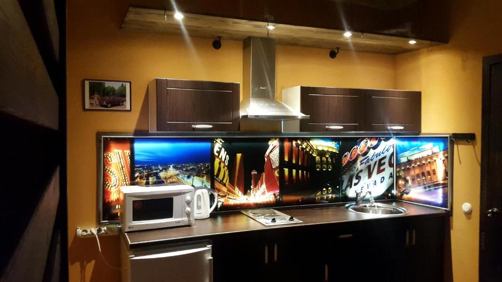 a kitchen with a counter with a microwave on it at Apartment on Lenina 18 in Novosibirsk