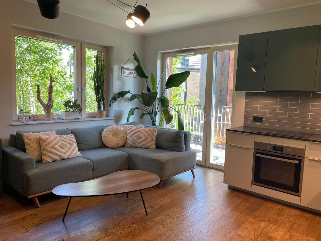 a living room with a couch and a table at River View Old Town in Gdańsk